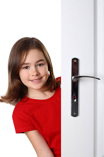 istock Girl peeking behind the door 146790408