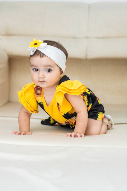 istock baby latina, crawling on top of the sofa, looking scared face 1467904391