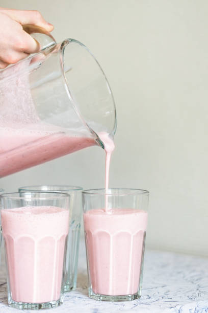 istock Strawberry milkshake pouring in glass. 1467904426