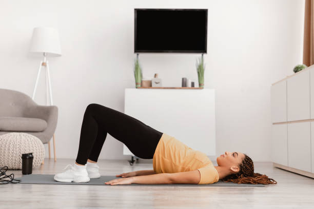 Fitness Woman With Braids Doing Bridge Exercise Training At Home