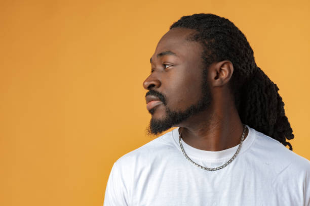 istock Handsome smiling young african man standing isolated over yellow background 1467905368