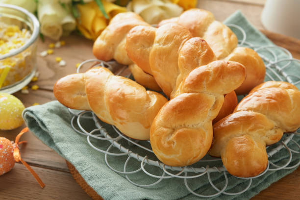 istock Easter breakfast Holliday concept. Easter bunny buns rolls with cinnamon made from yeast dough with orange glaze, easter decorations, colored eggs on old wooden background. Easter Holliday card. 1467905849