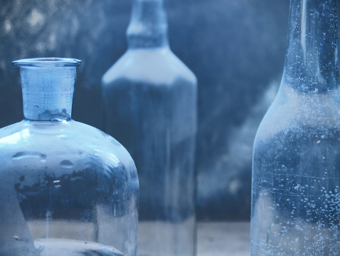 Still-life with three transparent glass bottles