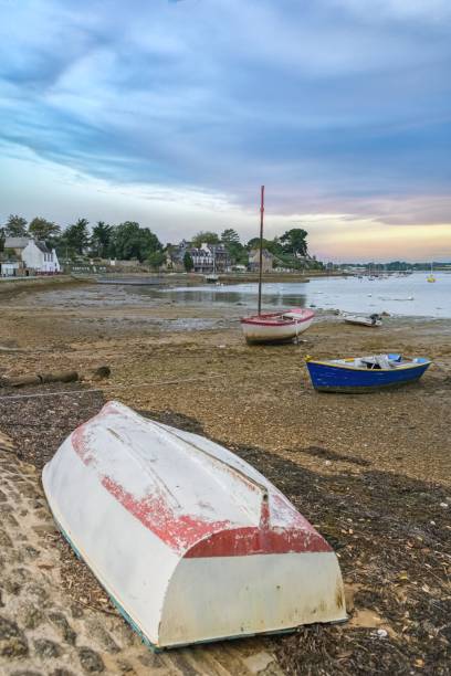 istock boats are pulled up on a beach at dusk on a cloudy day 1467907240