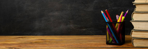 istock Back to school concept. School supplies on black board background. 1467910027