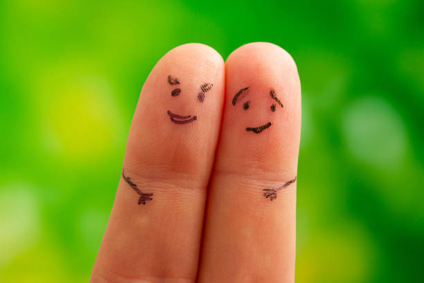 Happy family concept. Having fun outdoors and smiling. Fingers