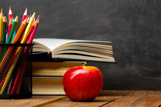 School supplies on black board background. Back to school concept