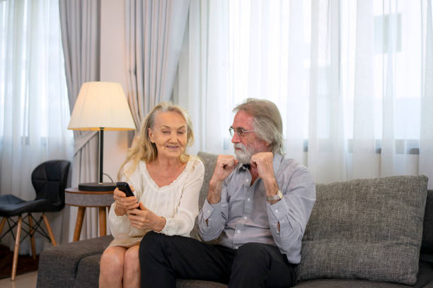istock Senior couple watch television at home. 1467913065