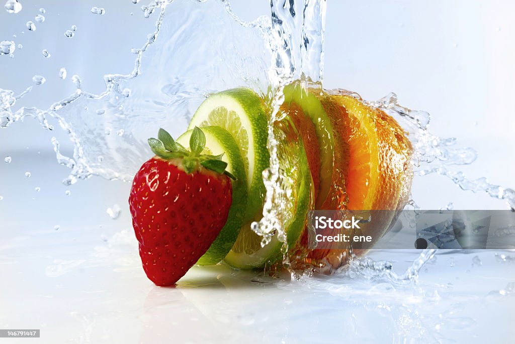 Strawberry and sliced citrus splashed with water water splashing over sliced fruits Freshness Stock Photo