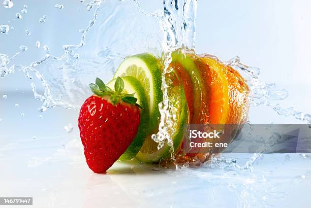 Strawberry And Sliced Citrus Splashed With Water Stock Photo - Download Image Now - Freshness, Orange - Fruit, Splashing