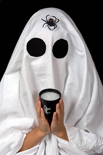 istock ghost child hold an halloween candle and a 146791552