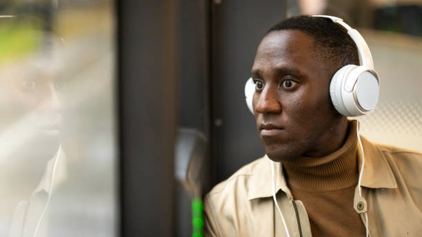 istock Young man listening music in bus 1467916256