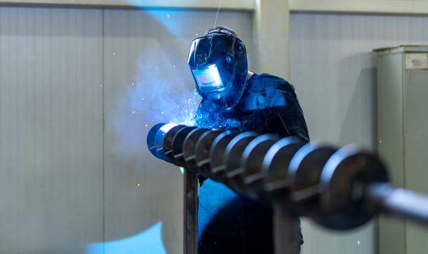 istock Welding specialist working with protective mask. Factory metal worker welding. 1467917329