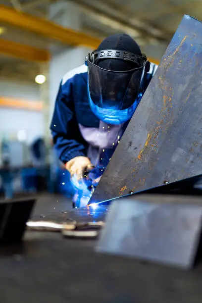Metal welding specialist. Engineering welder working in metal factory.