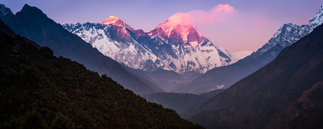 Mt. Everest, Nuptse and Lhotse glowing in the last light of sunset guarding the Khumbu valley high in the Himalayan mountains of Nepal.