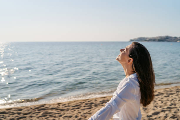 istock Young Woman Feeling Relieved On The Beach 1467918267