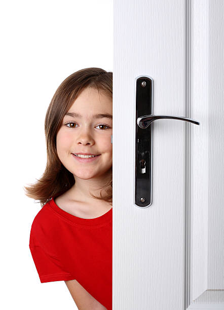 istock Girl peeking behind the door 146792119