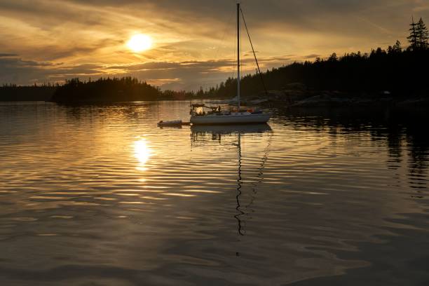 istock Dusk on the water.  A sailboat in a tranquil setting at sunset. 1467923204