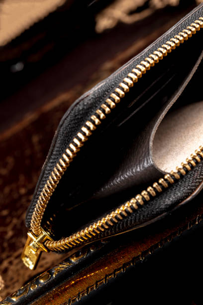istock Leather wallet with a golden zipper close-up on a dark background. 1467924932