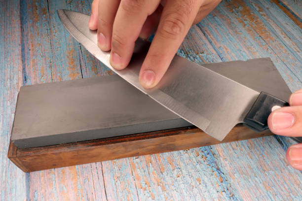 istock hand of a man sharpening a knife 1467925020