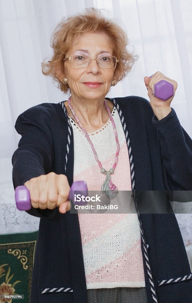 Healthy over 60 Beautiful senior woman exercise at home.	 65-69 Years Stock Photo