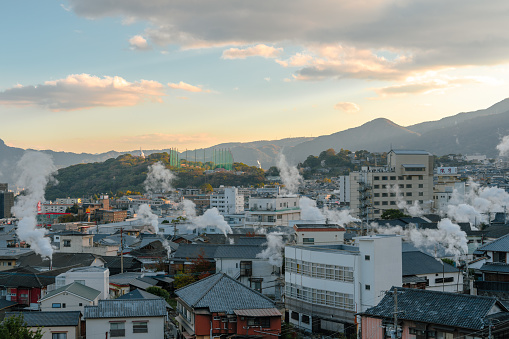 Oita, Japan - December 6, 2022 : Beppu onsen village panoramic view at sunset