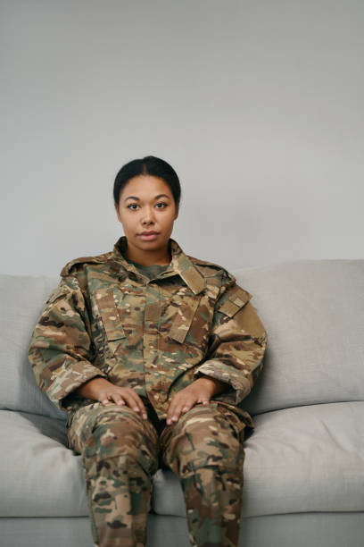 istock Woman in camouflage clothes sits on a soft sofa 1467929981