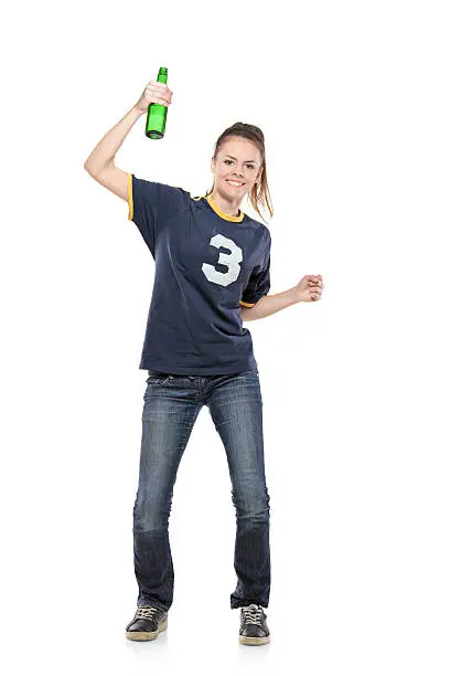 Photo of Female sport fan celebrating with a bottle in her hand