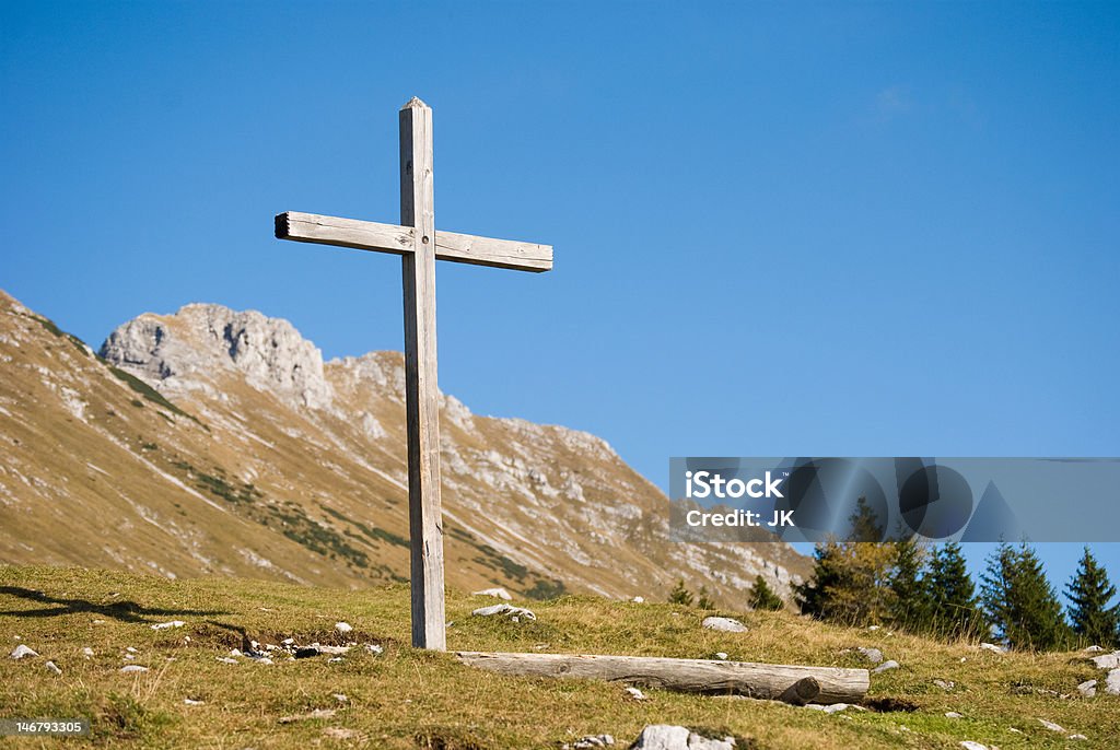 Wooden christian cross in mountains - horizontal shot Wooden christian cross in slovenian Alps Cross Shape Stock Photo