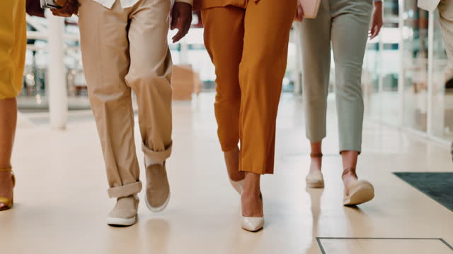 Office, shoes and group of business people walking together to a corporate work meeting. Professional, walk and feet of employees with fancy, luxury and stylish footwear in the modern workplace.