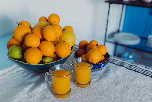 A view of lemons, limes and oranges with fresh squeezed orange juice on the table in the authentic Mediterranean kitchen in Turkey