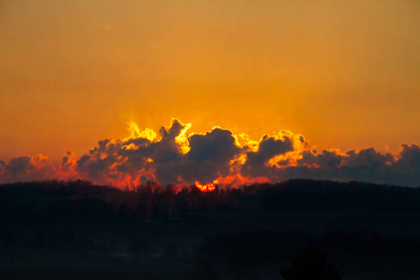 Vibrant colors of the setting sun as though it is setting the sky on fire.