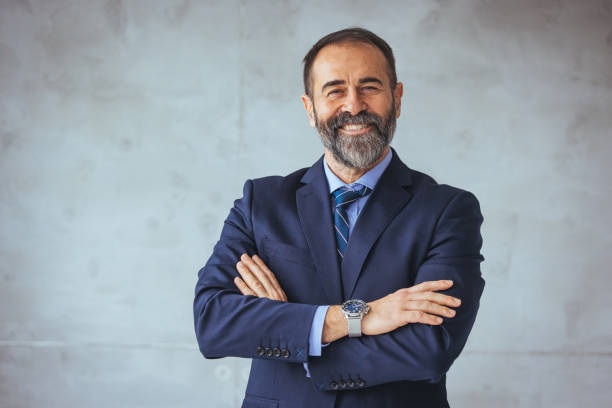 istock Businessman looking at the camera while standing alone in a modern workplace. 1467936888