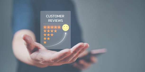 Evaluation and satisfaction concept. A thumps up that is an excellent review with unidentified model. Medium close up shot on businesswoman raised thumps up with a smile face emoticon with copy space.