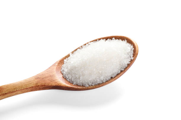 istock Granulated sugar in wooden spoon isolated on white 1467937567