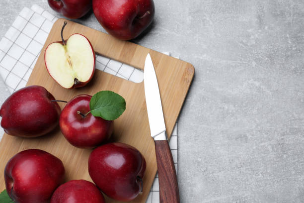 istock Fresh ripe red apples and knife on light grey table, flat lay. Space for text 1467937791