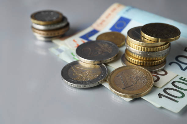 istock Euro banknotes and coins on light table, closeup 1467937796