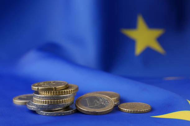 istock Many different coins on European Union flag, space for text 1467938539