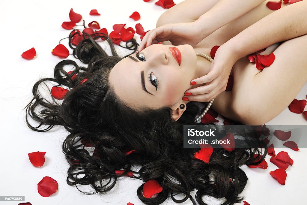 beautiful young nude woman beautiful young nude woman with red  rose petals isolated on white Adult Stock Photo