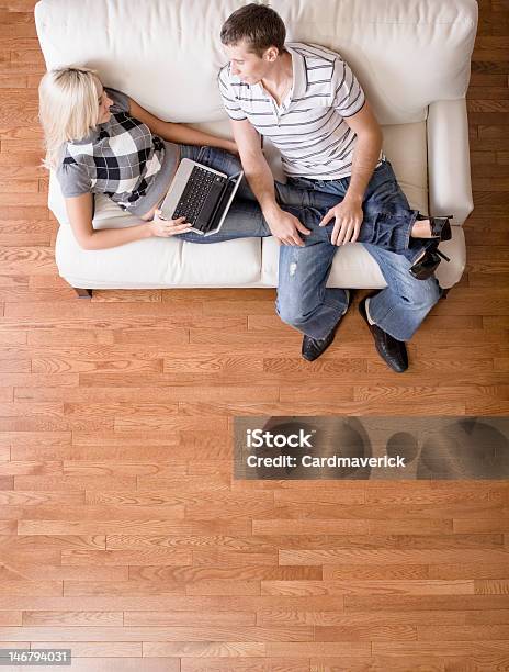 Overhead View Of Couple Relaxing On Couch Stock Photo - Download Image Now - Hardwood Floor, High Angle View, Living Room