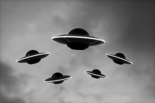 UFOs flying in sky, Digitally Generated Image.