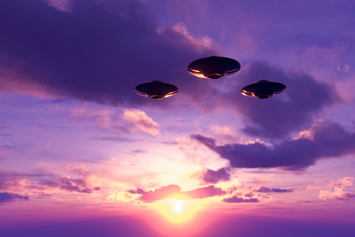 UFOs flying in sky, Digitally Generated Image.