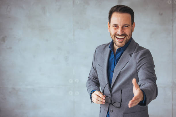 istock Businessman reaching out his hand for a handshake. 1467941650