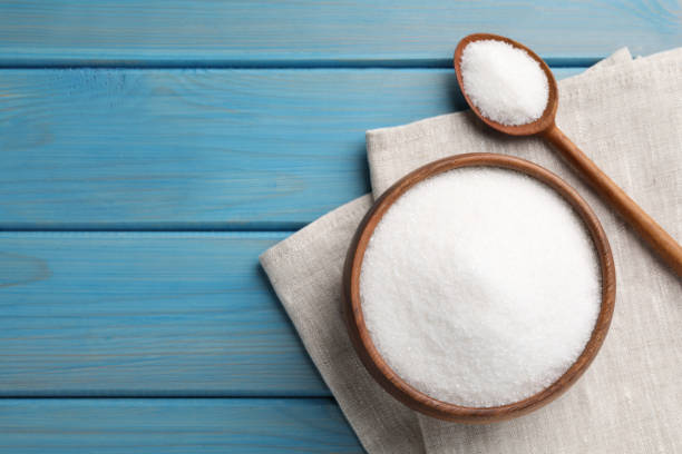 istock Granulated sugar on turquoise wooden table, flat lay. Space for text 1467942424