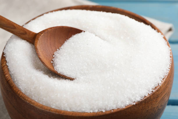 istock Granulated sugar and spoon in bowl on table, closeup 1467942522