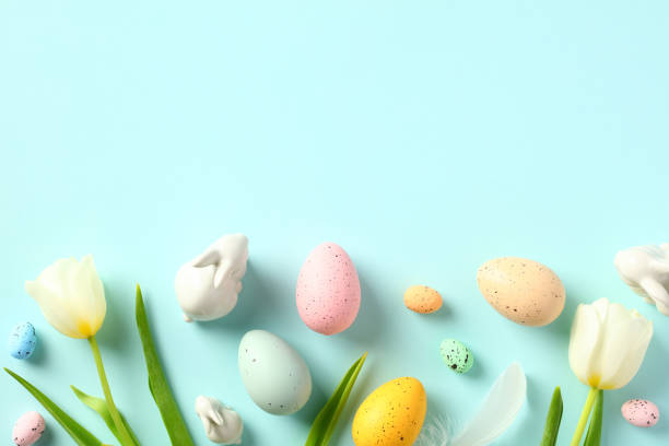 istock Easter eggs and tulips on pastel blue background. Happy Easter concept. Flat lay, top view. 1467946466