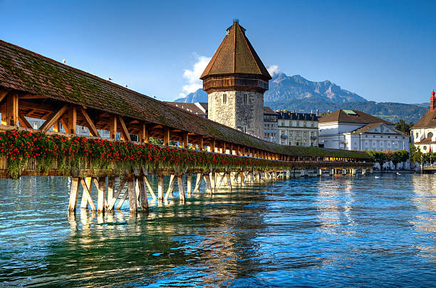 Wooden bridge over river in Lucerne stock photo