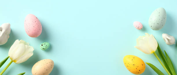 istock Happy Easter banner design. Easter Eggs, bunny, tulips on pastel blue background. Flat lay, top view. 1467947234