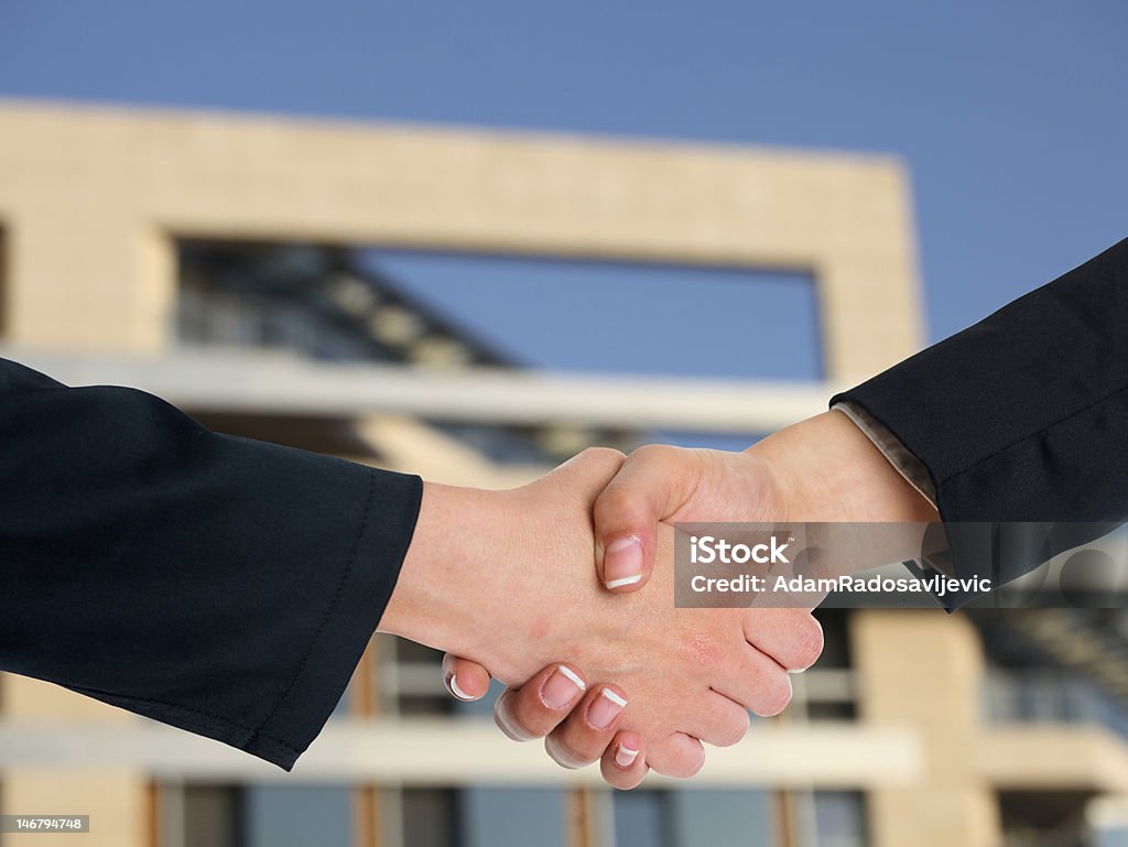 Architectural Handshaking in front of building Handshake Handshaking and blured building in background Agreement Stock Photo