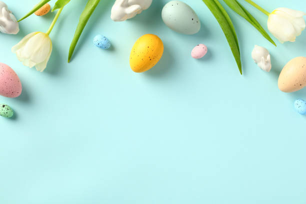 istock Easter Eggs and tulips on pastel blue background. Happy Easter greeting card. Flat lay, top view, copy space. 1467947494
